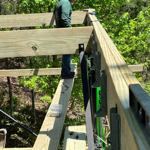 Pressure-treated deck rail post and cap being fitted