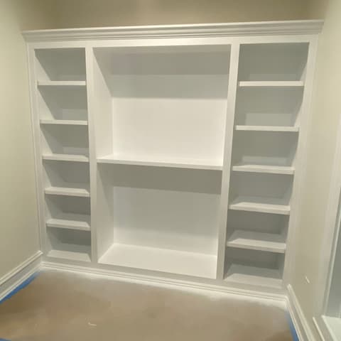 Finished white built-in wall unit with open shelving