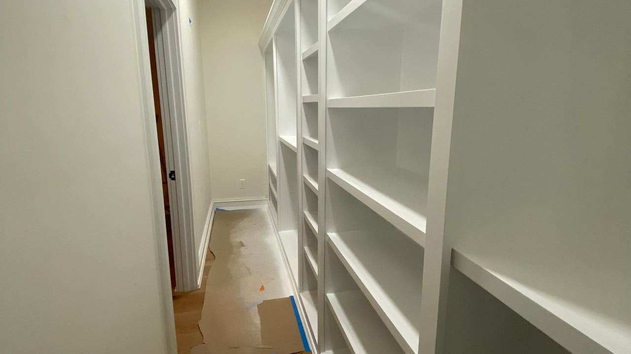 A hallway of built-in shelving finished by Jireh Painting and Remodeling