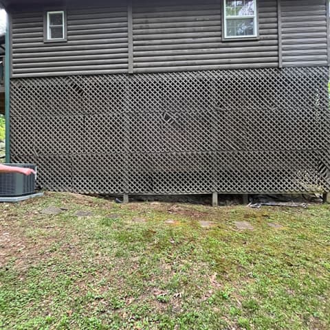 New lattice privacy screen fitted under a log cabin deck